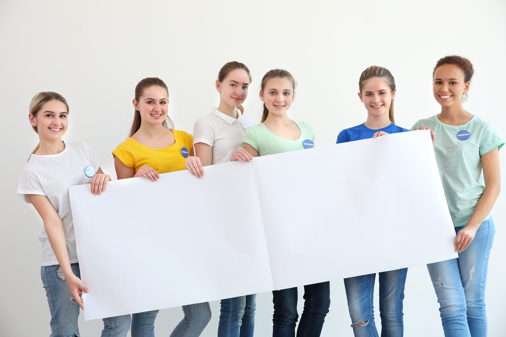 Young Volunteers with Poster on White Background